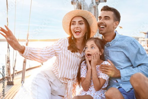 Fototapeta Happy young family resting on yacht