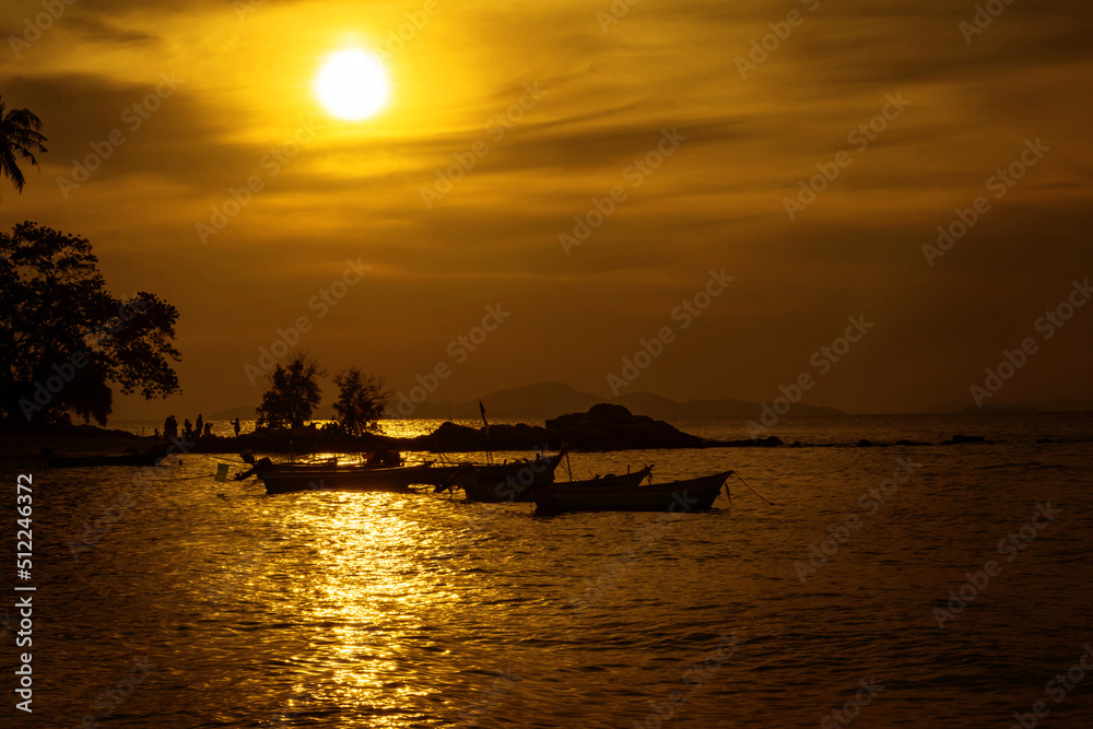 View of fishing boats moored on the seashore in the twilight.