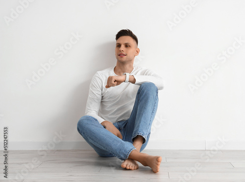 Young barefoot man with sma...