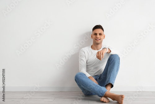 Young barefoot man with sma...
