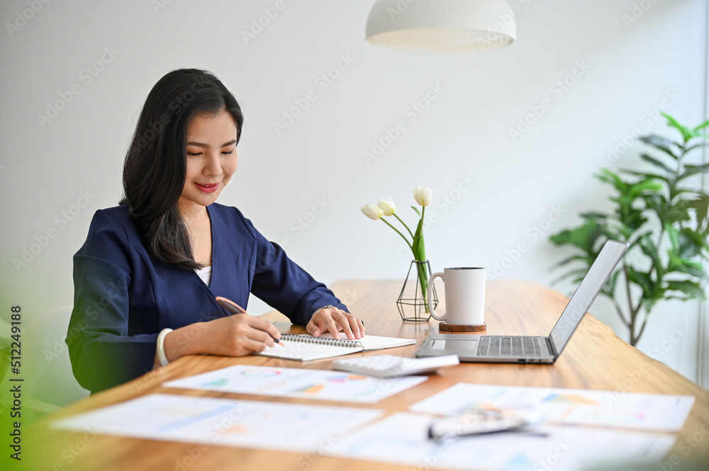Professional asian businesswoman woking on her business assignment Professional asian businesswoman woking on her business assignment