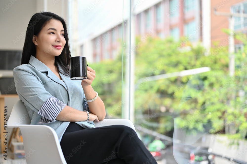Successful asian female executive manager or businesswoman sipping a coffee Successful asian female executive manager or businesswoman sipping a coffee