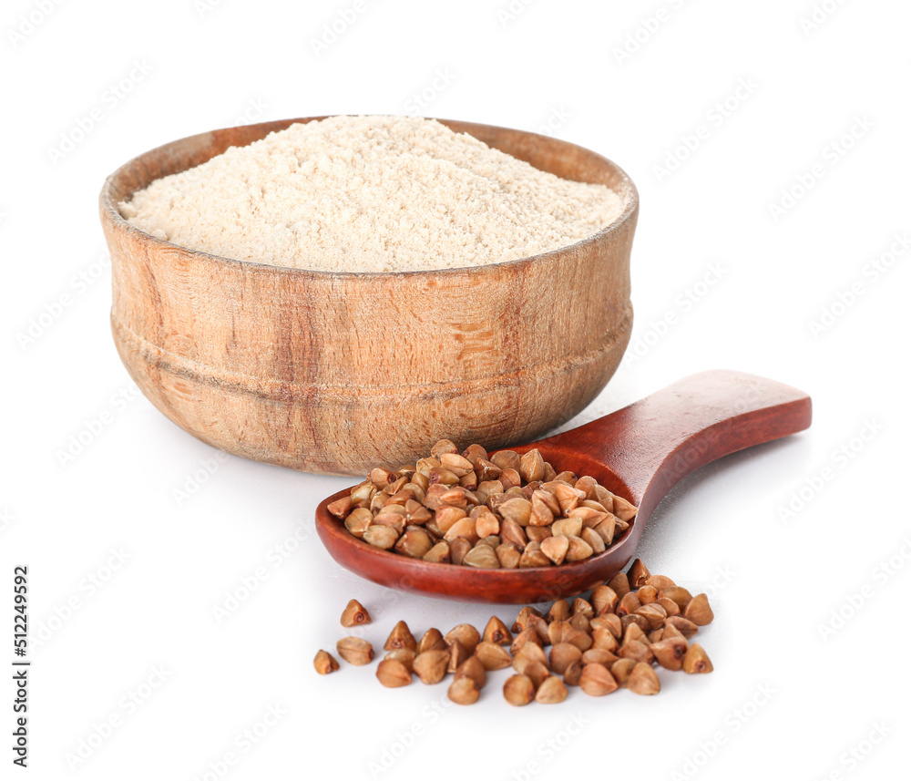 Bowl of flour and spoon with buckwheat grains on white background Bowl of flour and spoon with buckwheat grains on white background