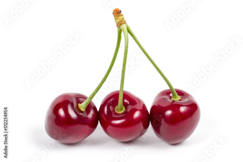 Three ripe cherries on a white background.