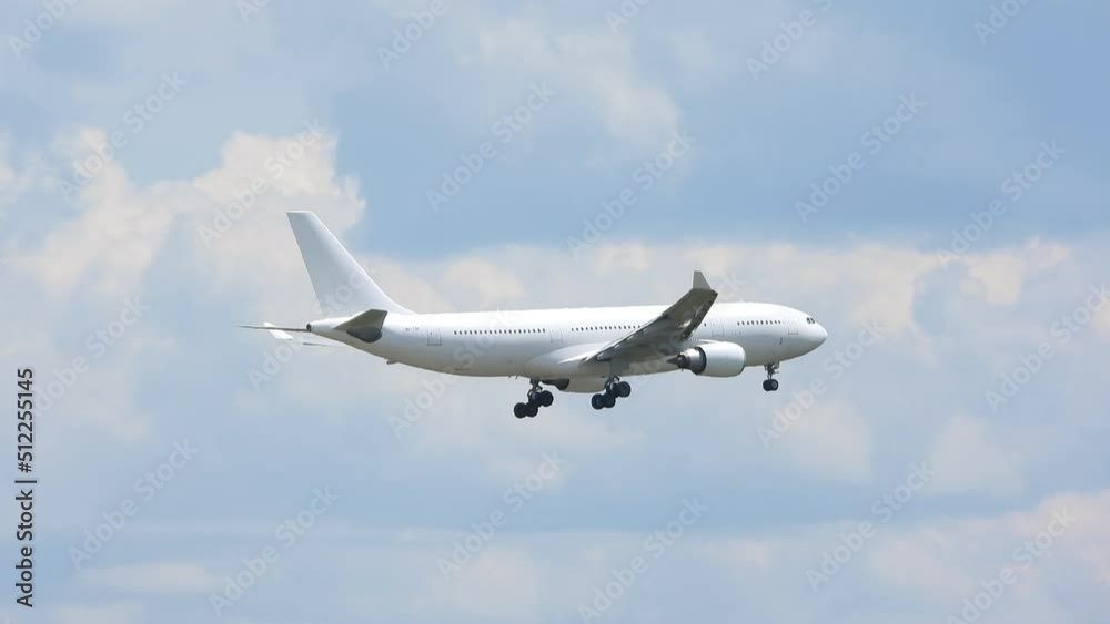 White flying airplane middle of cloudy sky tracking closeup White flying airplane middle of cloudy sky tracking closeup