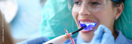 Konstfotografi Dentist works with dental polymerization lamp in oral cavity