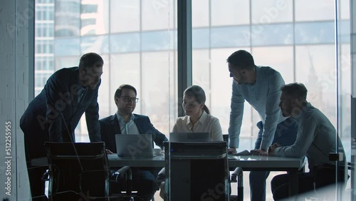Group of business people working at a table at meeting room. Mature business people working with laptop