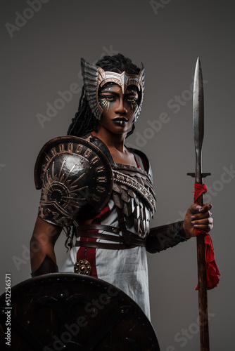 Cuadro en lienzo Portrait of elegant black woman amazon dressed in armor holding shield and spear