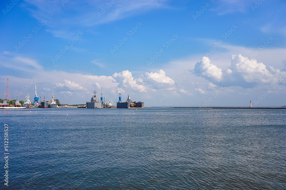 Seascape with war ships under the blue sky.