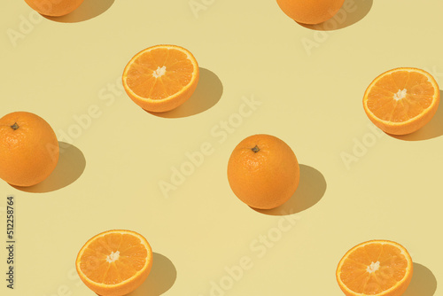 Trendy pattern with fresh orange on a yellow background. Minimal summer wallpaper.