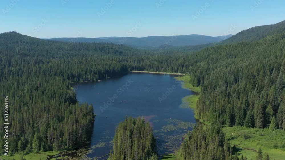Aerial descending and flying toward Trillium Lake in the Mt. Hood National Forest in Oregon during summertime. Aerial descending and flying toward Trillium Lake in the Mt. Hood National Forest in Oregon during summertime.