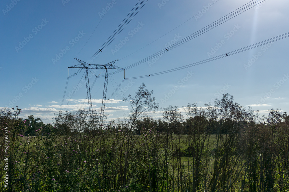 High tension electricity pylons crossing farmlands