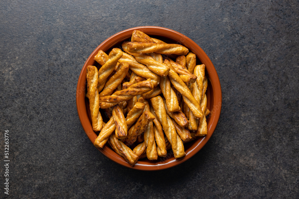 Salted pretzel sticks. Salted crackers in bowl. Salted pretzel sticks. Salted crackers in bowl.