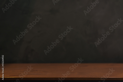 Empty old tabletop in front of blurred blank Blackboard Background in class room. Can be used for display or montage for show your products.