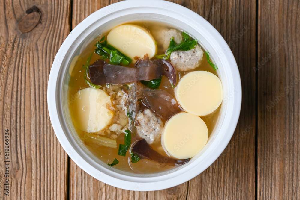 Menu healthy food egg tofu soup , clear soup bowl with pork jelly mushroom black jelly fungus vegetable and celery , vermicelli soup Menu healthy food egg tofu soup , clear soup bowl with pork jelly mushroom black jelly fungus vegetable and celery , vermicelli soup