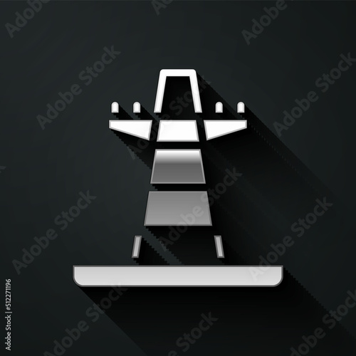 Silver Electric tower used to support an overhead power line icon isolated on black background. High voltage power pole line. Long shadow style. Vector