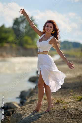 Wallpaper Mural Beautiful woman in white dress on the bank of a river in summer. Torontodigital.ca