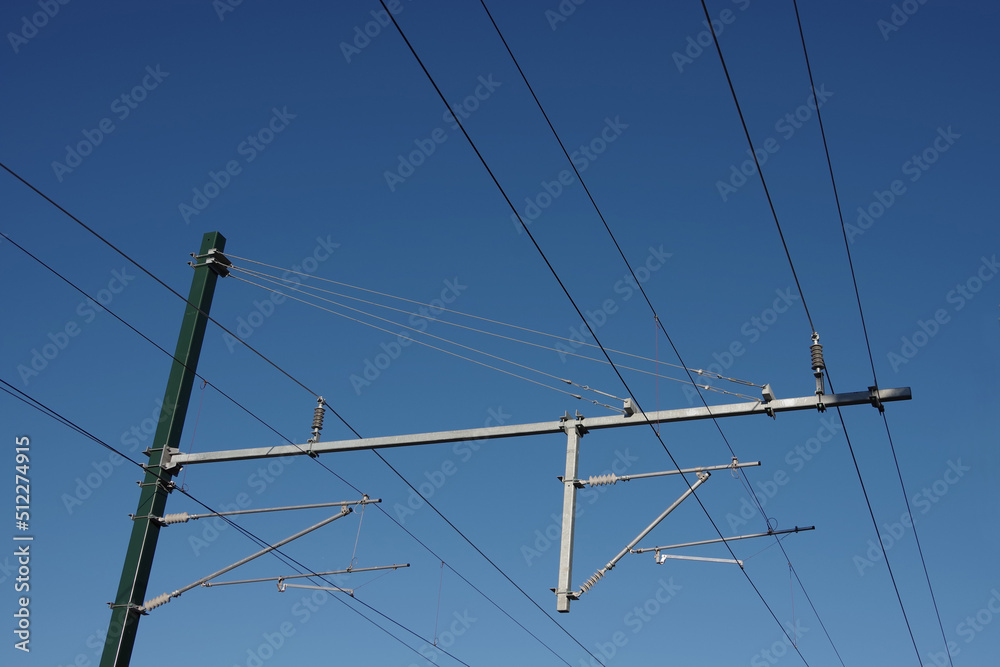 Electric railroad overhead lines under blue sky Electric railroad overhead lines under blue sky