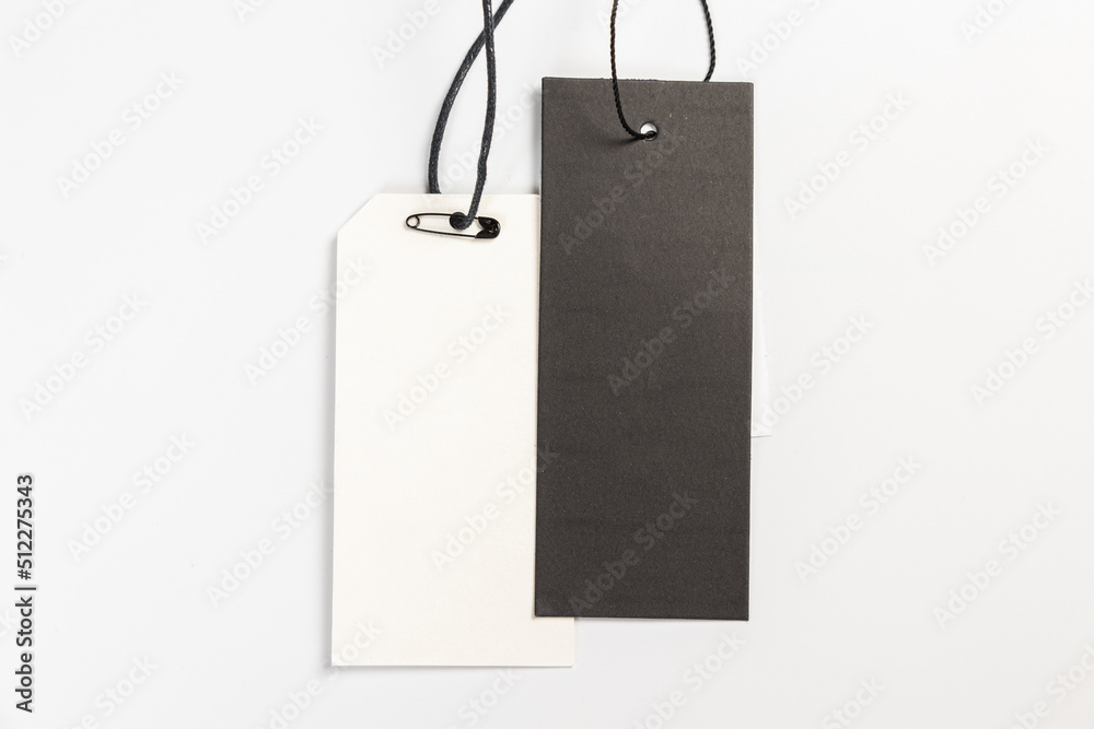 a pair of fashionable blank labels for clothes on a gray background