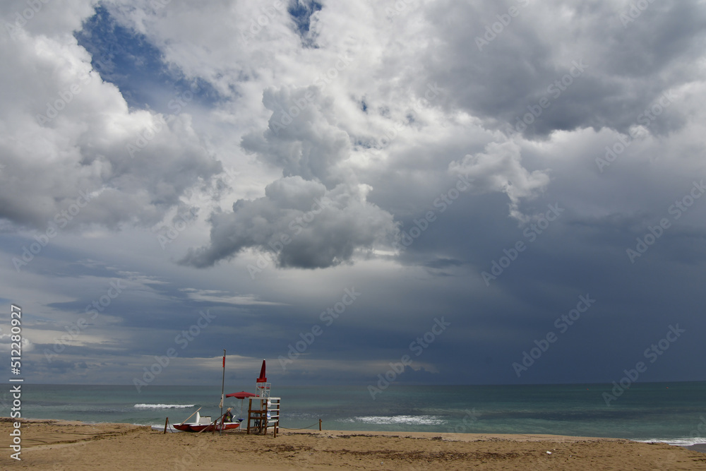 Stormy clouds over a sandy beach of Salento in Italy. Stormy clouds over a sandy beach of Salento in Italy.