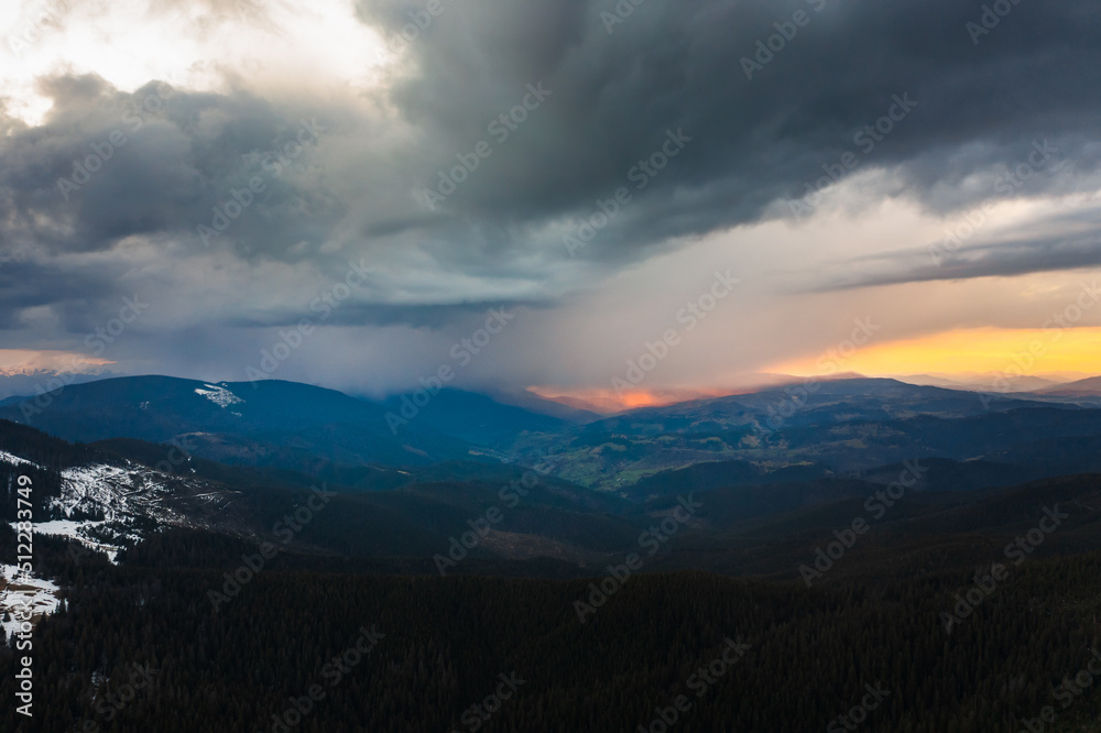 Cloudy skies over the mountains, rainy spring clouds over the forest and mountain tops.