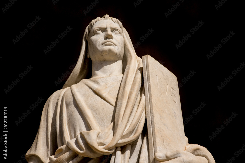 Closeup of a travertine marble statue on a black background