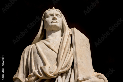 Closeup of a travertine marble statue on a black background