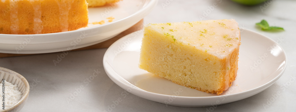 Delicious Lemon Glazed Pound Sponge cake on white marble table background. Delicious Lemon Glazed Pound Sponge cake on white marble table background.