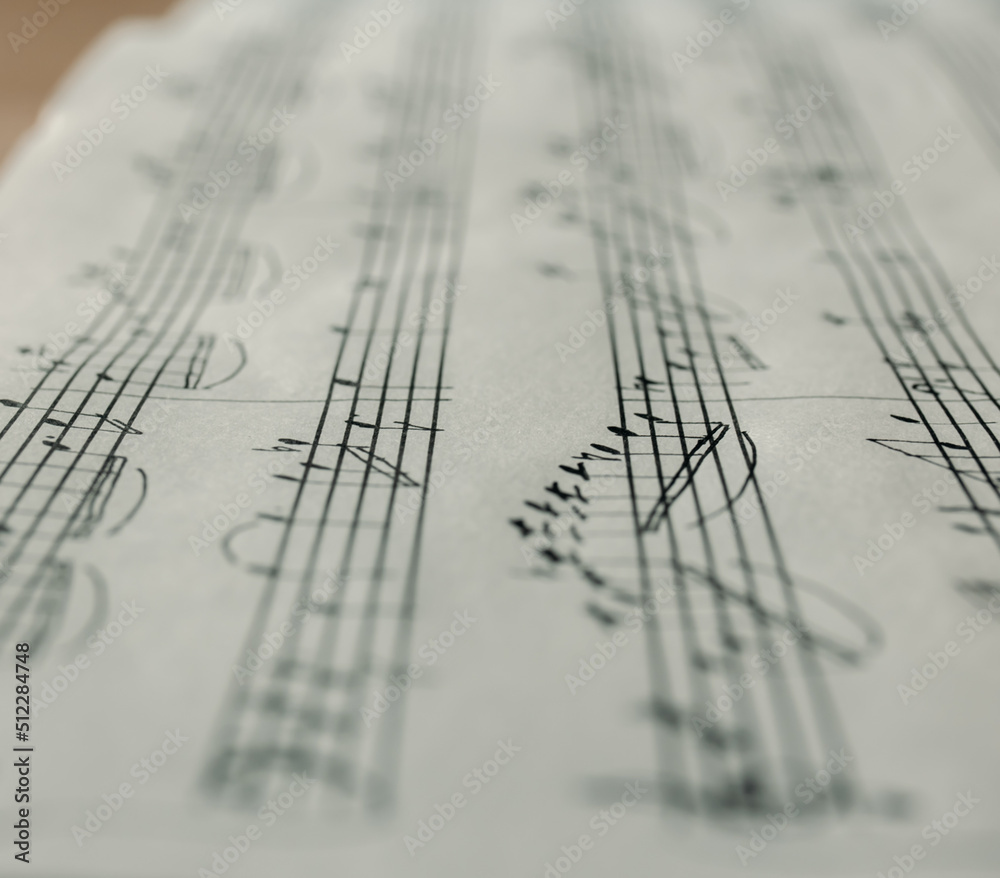 Music notes macro background, handwritten notes, selective focus Music notes macro background, handwritten notes, selective focus