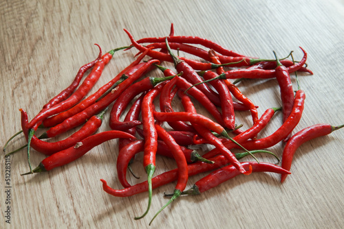 red chili peppers with wooden background