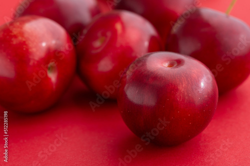 Plums are on a red background.