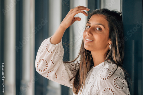 beautiful woman brushing her hair on the wall photo