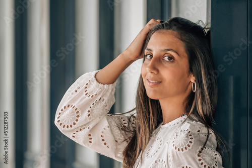 beautiful woman brushing her hair on the wall photo