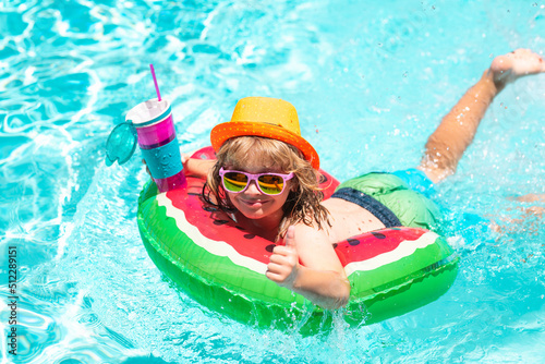 Child in swimming pool. Summer activity. Healthy kids lifestyle.