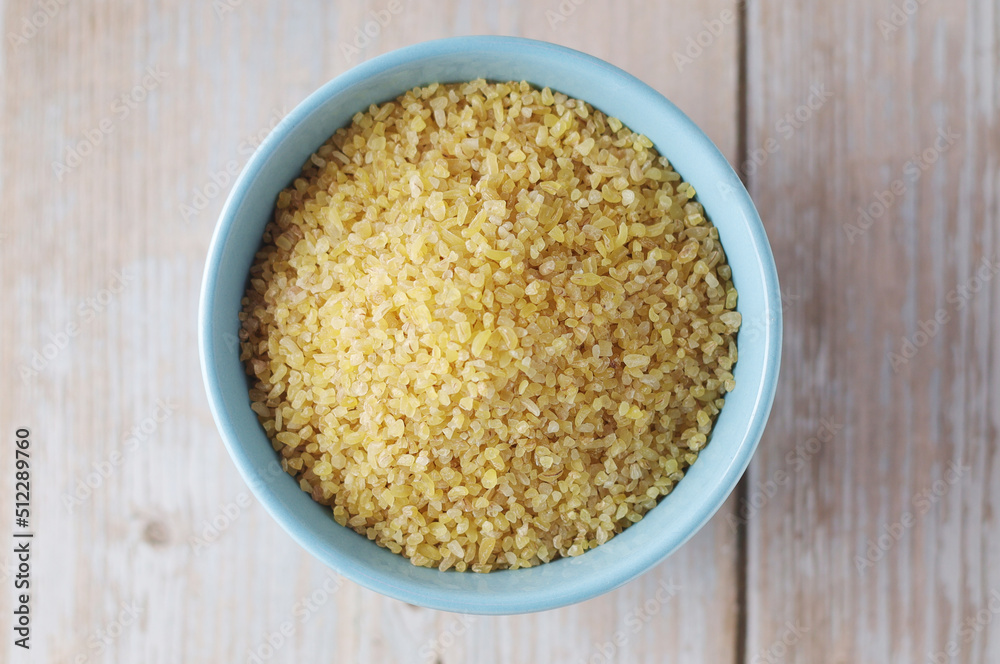 Dry uncooked bulgur in a ceramic bowl Dry uncooked bulgur in a ceramic bowl