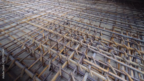 Industry background. Texture of reinforcement. Rusty reinforcement for pouring concrete. Steel reinforcing bars. Reinforcement of construction reinforcement works. Close-up of steel reinforcement. photo