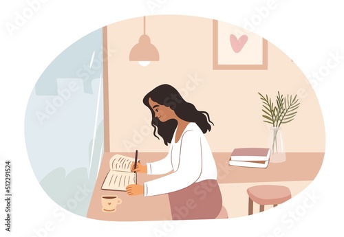 Young woman writing and studying at cafe.