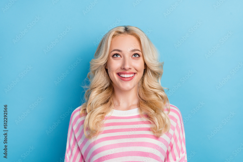 Photo of lovely young blond hairdo lady look up wear pink shirt isolated on blue color background Photo of lovely young blond hairdo lady look up wear pink shirt isolated on blue color background