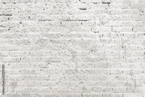 Texture of old brick wall sprayed with stucco mortar as background