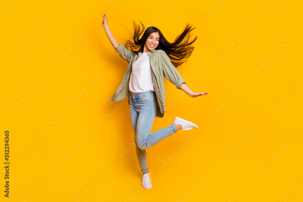 Full body portrait of positive overjoyed girl enjoy dancing clubbing isolated on yellow color background Full body portrait of positive overjoyed girl enjoy dancing clubbing isolated on yellow color background
