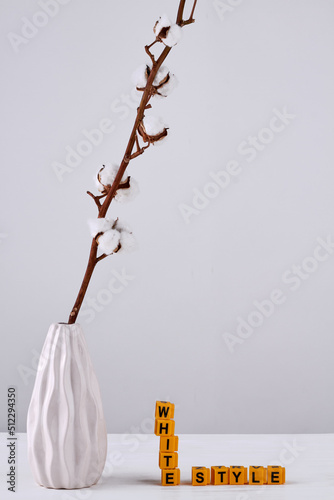 White vase of pussy willow and yellow letter cubes. White style concept. Vertical shot whote background. photo