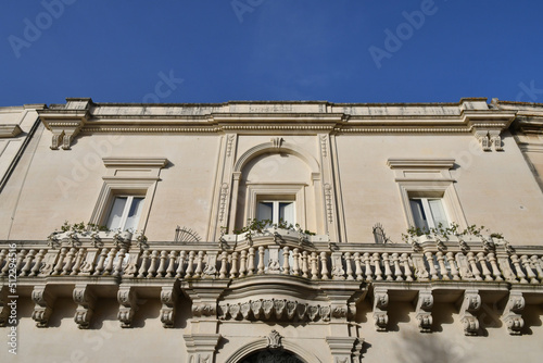 The balcony of an old Baroque style house in Maglie, a village in the Puglia region of Italy. 