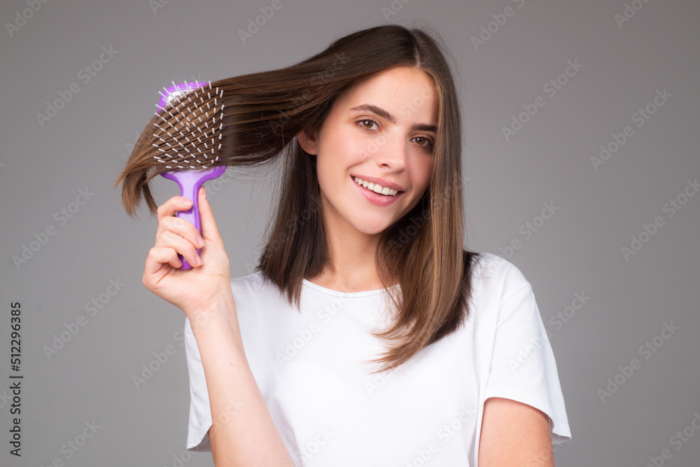 Beautiful woman combs her healthy hair. Combing healthy long straight female hair, close up. Beautiful woman combs her healthy hair. Combing healthy long straight female hair, close up.