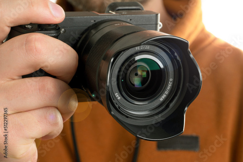 A close up image of man holding digital camera