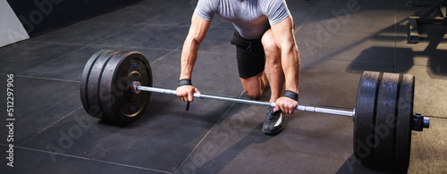 Close up of hand of man doing deadlift exercise in gym. Banner size