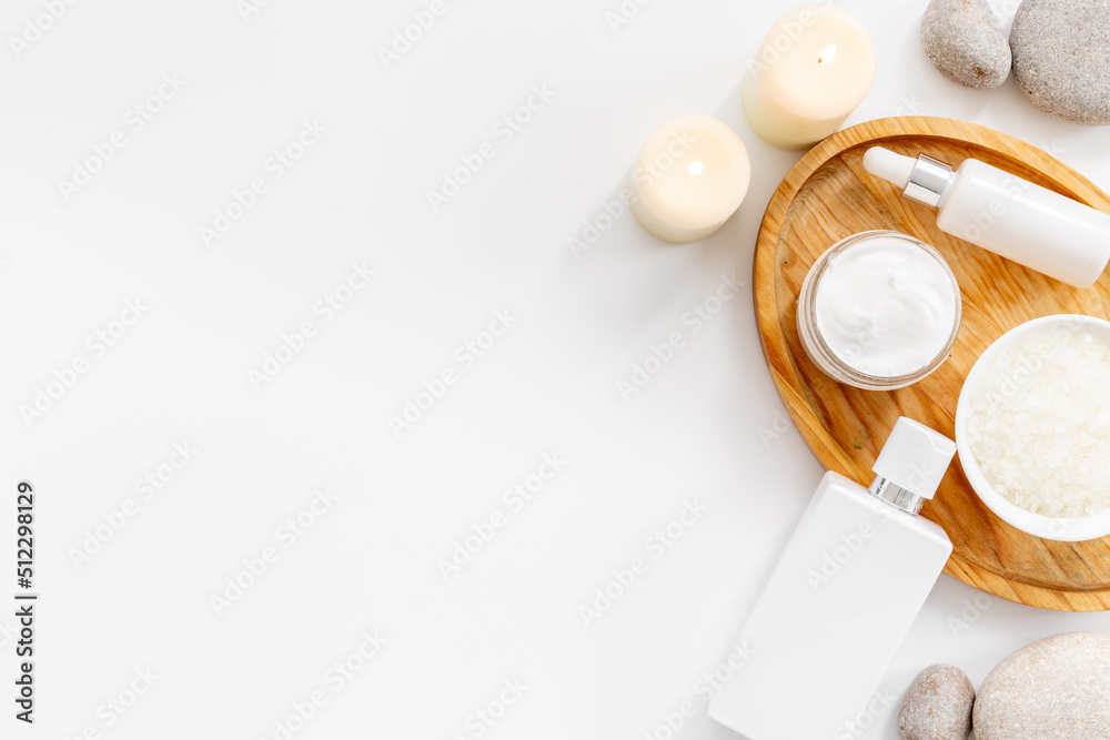 White cosmetic products with bottle and tube, top view White cosmetic products with bottle and tube, top view