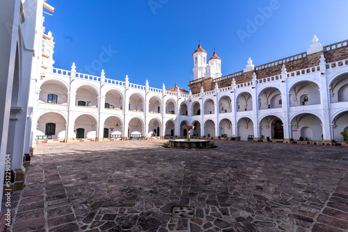 Courtyard of neoclassical style catholic church with arched passage photo