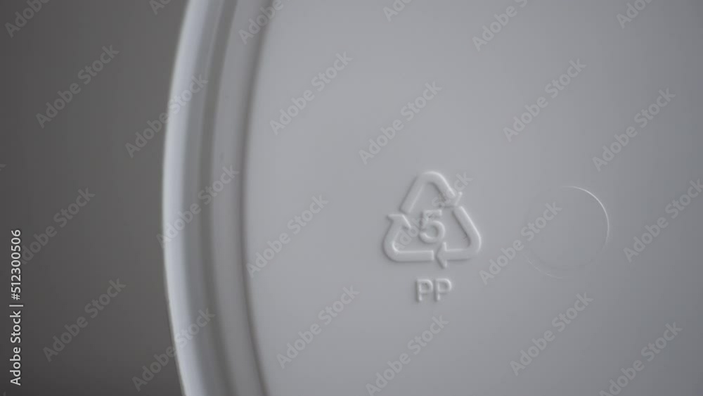 4k Closeup view of 05 pp recycling sign and on white product or trash packaging spbd. Polypropylene: bottle caps, pails and buckets, yogurt cups, lens packaging, rustling plastic packs. It can be