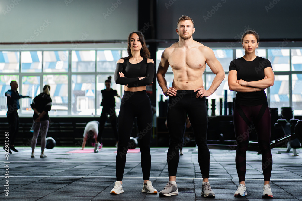 sexy caucasian man and women in gym train in fitness club with weights lifestyle wellness exercising with joy