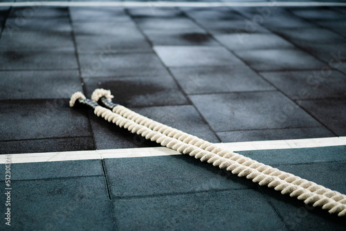 Ropes in the gym lie on the floor after a cardio workout